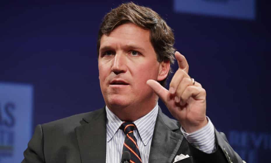 Tucker Carlson, seen here exaggerating the size of his penis.
